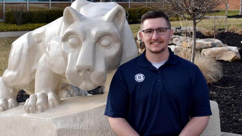 Lukas Salvo with the Lion Shrine on the campus of Penn State DuBois